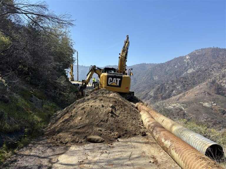 Road construction crews use an excavator and backhoe to remove old culverts and break rock for installation of new culverts along Mineral King Road. Full roadway closures for this work are required for safety on this narrow, curvy mountain road.